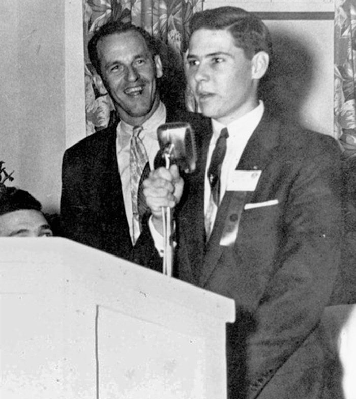 Bob Graham delivers a speech while audience member smiles